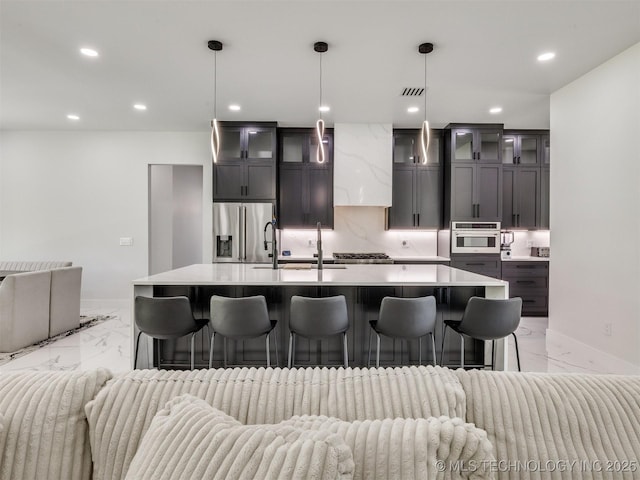 11446 Mary Knox Dr, Beggs, OK 74421 - kitchen with light marble finish floors, appliances with stainless steel finishes, open floor plan, light countertops, and a large island