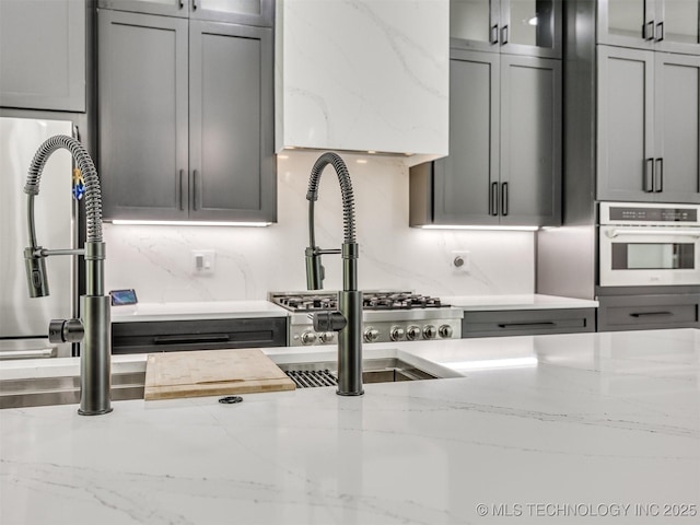 11446 Mary Knox Dr, Beggs, OK 74421 - kitchen with stainless steel oven, light stone countertops, and gray cabinets