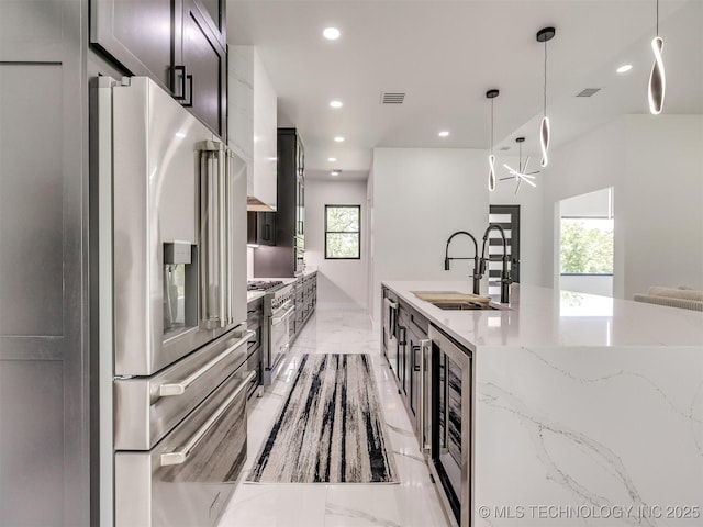 11446 Mary Knox Dr, Beggs, OK 74421 - kitchen with appliances with stainless steel finishes, light marble finish flooring, wine cooler, recessed lighting, and pendant lighting