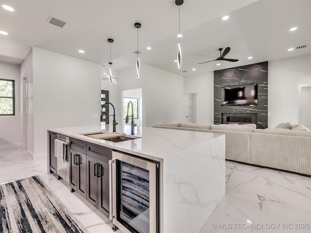 11446 Mary Knox Dr, Beggs, OK 74421 - kitchen with beverage cooler, light marble finish flooring, recessed lighting, hanging light fixtures, and open floor plan