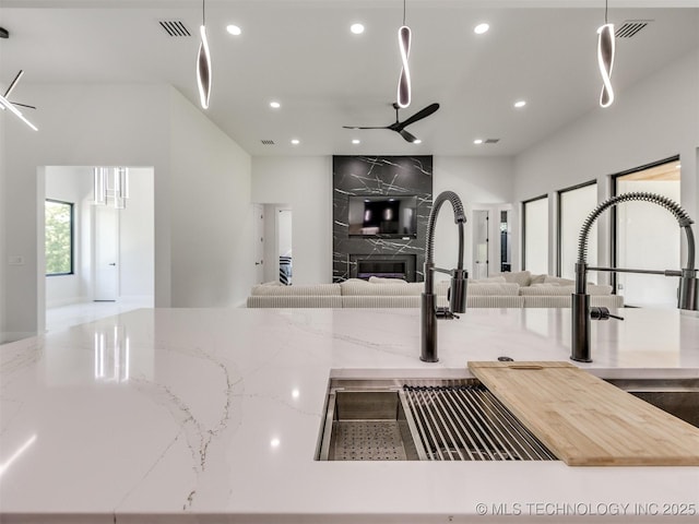 11446 Mary Knox Dr, Beggs, OK 74421 - kitchen with open floor plan, recessed lighting, a premium fireplace, ceiling fan, and light stone countertops