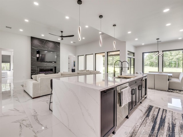 11446 Mary Knox Dr, Beggs, OK 74421 - kitchen with recessed lighting, light marble finish floors, open floor plan, a large island with sink, and ceiling fan