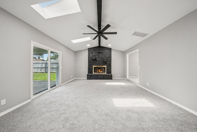 2712 S Fir Ave, Broken Arrow, OK 74012 - unfurnished living room featuring a skylight, carpet, a stone fireplace, and recessed lighting