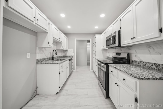 2712 S Fir Ave, Broken Arrow, OK 74012 - kitchen with appliances with stainless steel finishes, light marble finish floors, recessed lighting, light stone countertops, and tasteful backsplash