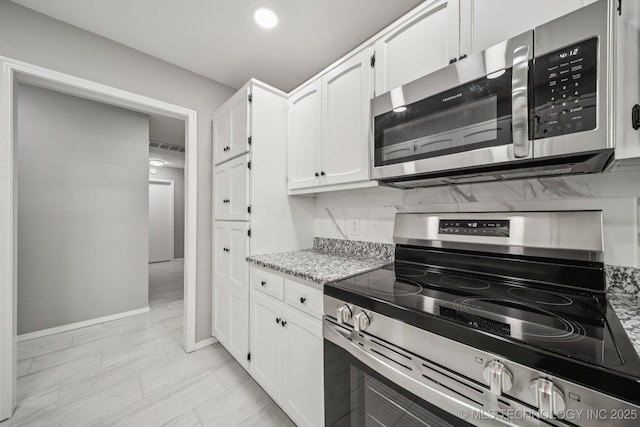 2712 S Fir Ave, Broken Arrow, OK 74012 - kitchen with stainless steel appliances, white cabinetry, backsplash, light stone countertops, and light marble finish floors
