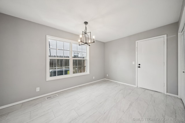 2712 S Fir Ave, Broken Arrow, OK 74012 - empty room with a chandelier and light marble finish floors