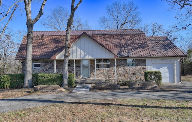 96539 S 4550th Rd, Vian, OK 74962 - view of front of home with driveway, a metal roof, an attached garage, and stone siding