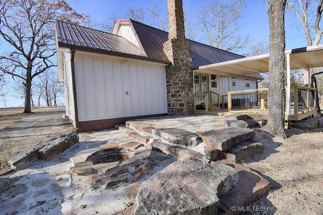 96539 S 4550th Rd, Vian, OK 74962 - back of house with a chimney, an outdoor fire pit, and a metal roof