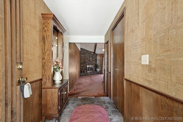12452 E 36th St, Tulsa, OK 74146 - hall featuring a textured ceiling and wooden walls