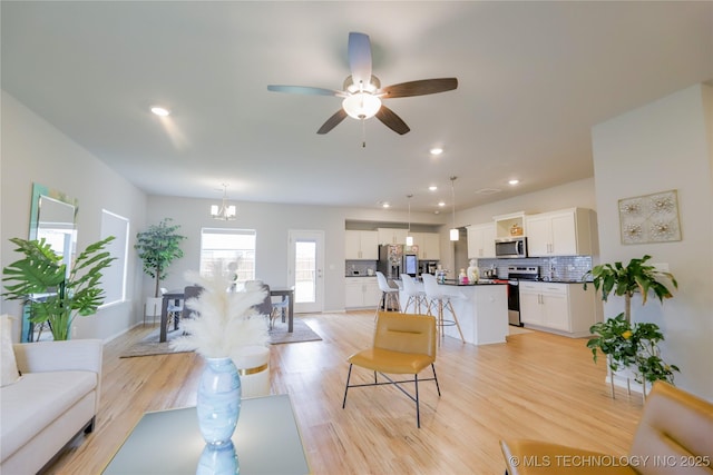 9516 E 131st Pl S, Bixby, OK 74008 - living area featuring a chandelier, light wood-type flooring, a ceiling fan, and recessed lighting