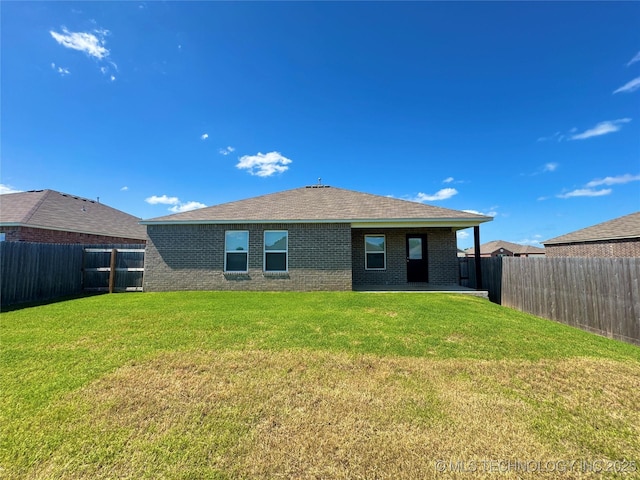 8314 E 162nd St S, Bixby, OK 74008 - back of house featuring brick siding, a fenced backyard, and a shingled roof