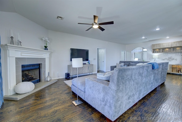 124 W 125th Ct S, Jenks, OK 74037 - living area featuring dark wood-style flooring, arched walkways, a ceiling fan, a tiled fireplace, and recessed lighting