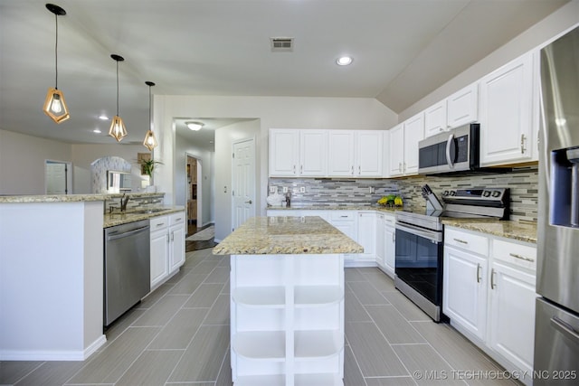 124 W 125th Ct S, Jenks, OK 74037 - kitchen with appliances with stainless steel finishes, backsplash, a center island, light stone countertops, and white cabinetry