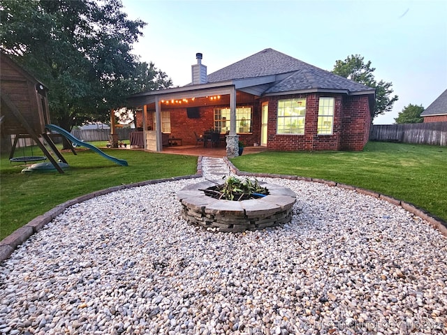 124 W 125th Ct S, Jenks, OK 74037 - back of property with a chimney, a playground, brick siding, and a fenced backyard