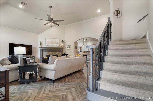 2611 S 15th Pl, Broken Arrow, OK 74012 - living area with a ceiling fan, arched walkways, ornamental molding, stairs, and a fireplace
