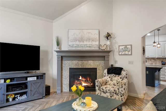 2611 S 15th Pl, Broken Arrow, OK 74012 - living area featuring crown molding, arched walkways, a fireplace, and vaulted ceiling