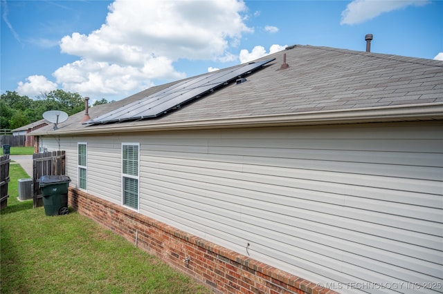 1330 Panther Ln, Sapulpa, OK 74066 - view of property exterior featuring roof mounted solar panels, roof with shingles, and brick siding