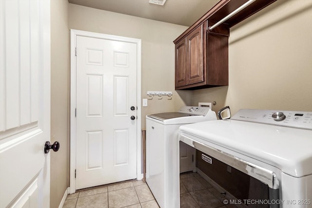 1801 E Montgomery St, Broken Arrow, OK 74012 - laundry area with washing machine and clothes dryer, cabinet space, and light tile patterned flooring