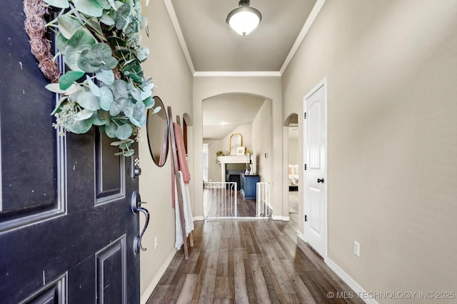 1801 E Montgomery St, Broken Arrow, OK 74012 - entryway with arched walkways, crown molding, wood finished floors, and a fireplace