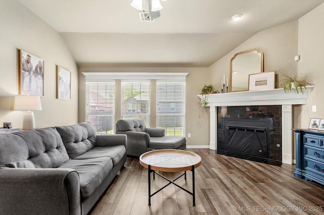 1801 E Montgomery St, Broken Arrow, OK 74012 - living room with vaulted ceiling, wood finished floors, a tiled fireplace, and ceiling fan
