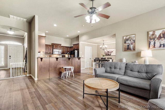 1801 E Montgomery St, Broken Arrow, OK 74012 - living room with ornamental molding, light wood-style floors, a ceiling fan, a chandelier, and recessed lighting