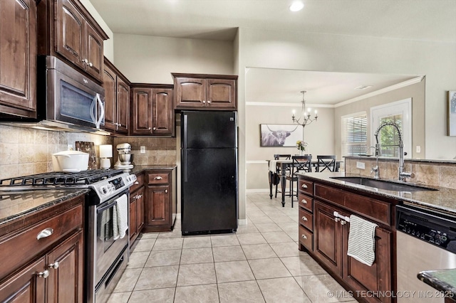 1801 E Montgomery St, Broken Arrow, OK 74012 - kitchen featuring stainless steel appliances, tasteful backsplash, dark stone countertops, crown molding, and a chandelier