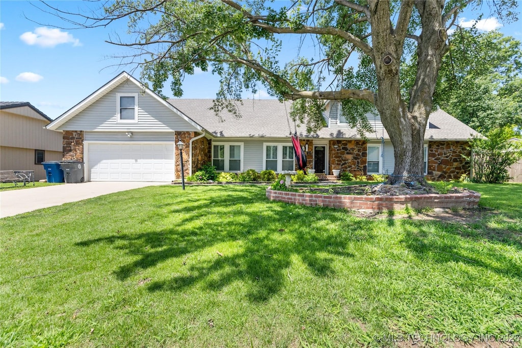 9208 S 70th Ave E, Tulsa, OK 74133 - view of front of property with stone siding, concrete driveway, a garage, and a front lawn