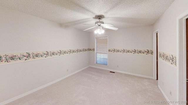 1124 Surrey Dr, Ardmore, OK 73401 - spare room featuring a ceiling fan, a textured ceiling, and light colored carpet