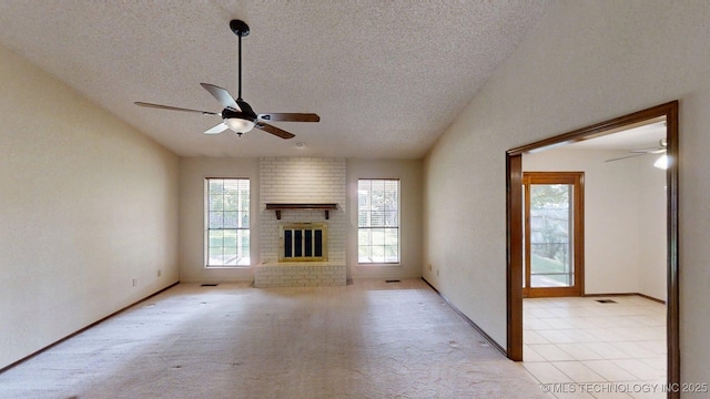 1124 Surrey Dr, Ardmore, OK 73401 - unfurnished living room with a ceiling fan, a textured ceiling, vaulted ceiling, and a brick fireplace