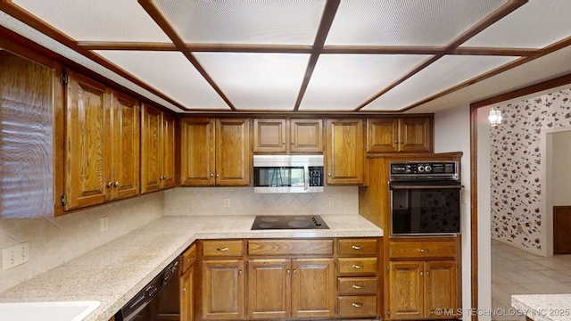 1124 Surrey Dr, Ardmore, OK 73401 - kitchen with black appliances, light countertops, tasteful backsplash, and brown cabinets