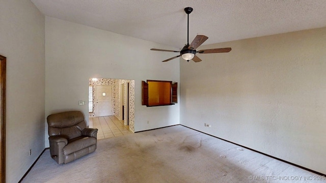 1124 Surrey Dr, Ardmore, OK 73401 - unfurnished room featuring a ceiling fan, carpet, high vaulted ceiling, and tile patterned floors