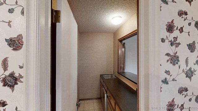1124 Surrey Dr, Ardmore, OK 73401 - bathroom with a textured ceiling, vanity, and tile patterned floors