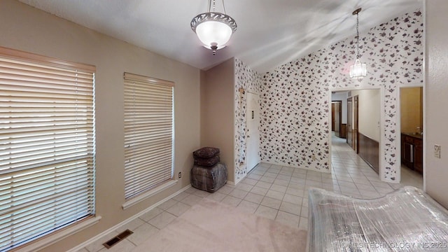 1124 Surrey Dr, Ardmore, OK 73401 - unfurnished dining area with light tile patterned floors, vaulted ceiling, and wallpapered walls