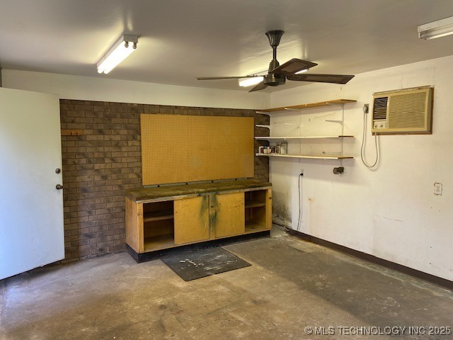 1124 Surrey Dr, Ardmore, OK 73401 - kitchen featuring open shelves, unfinished concrete flooring, a wall unit AC, and ceiling fan