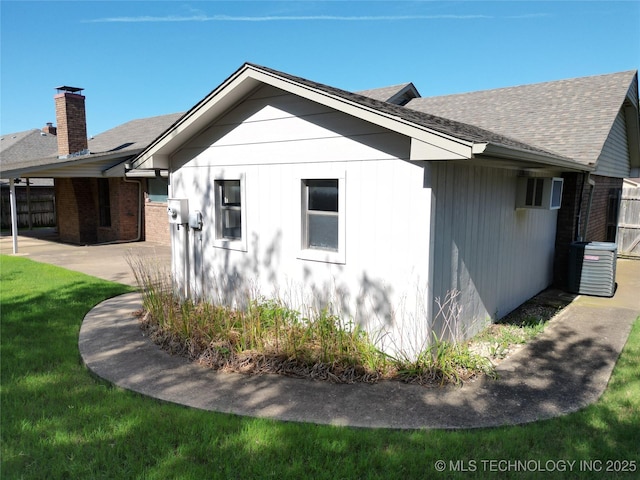 1124 Surrey Dr, Ardmore, OK 73401 - view of side of home featuring a shingled roof, brick siding, a chimney, and a patio area