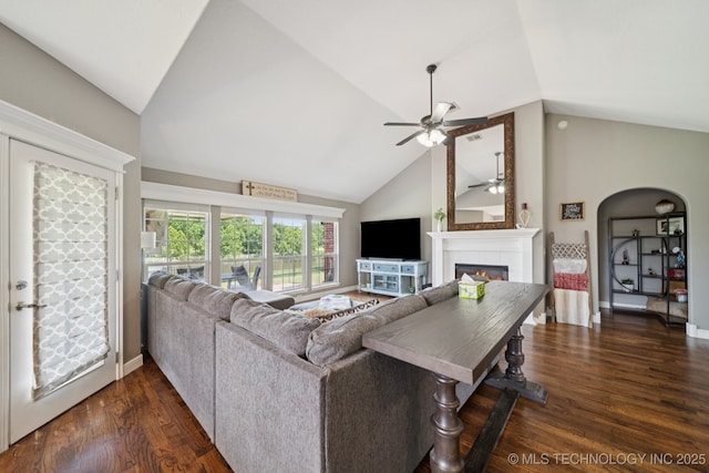 921 S 75th St, Broken Arrow, OK 74014 - living area with a ceiling fan, a tile fireplace, dark wood finished floors, arched walkways, and high vaulted ceiling