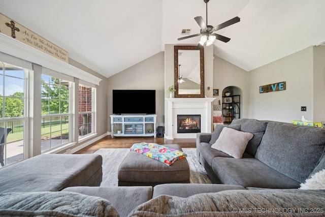 921 S 75th St, Broken Arrow, OK 74014 - living room with wood finished floors, high vaulted ceiling, ceiling fan, and a glass covered fireplace