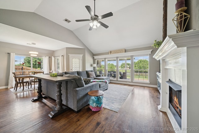 921 S 75th St, Broken Arrow, OK 74014 - living room featuring lofted ceiling, a glass covered fireplace, healthy amount of natural light, a ceiling fan, and wood finished floors