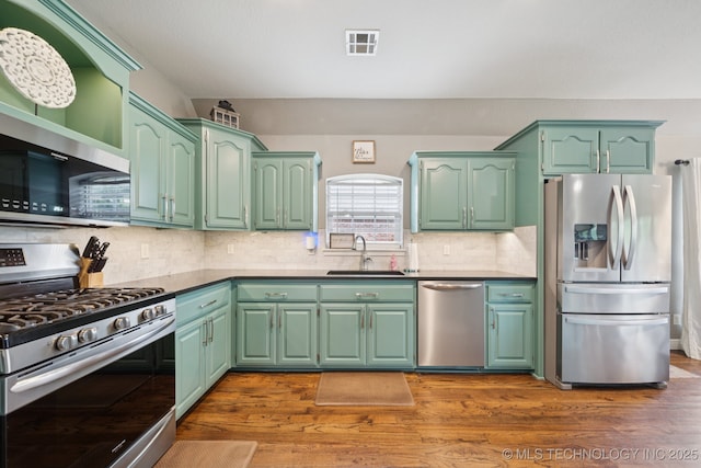 921 S 75th St, Broken Arrow, OK 74014 - kitchen with stainless steel appliances, dark wood-type flooring, and decorative backsplash