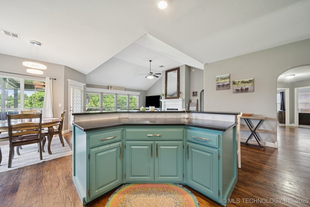 921 S 75th St, Broken Arrow, OK 74014 - kitchen with ceiling fan, arched walkways, dark countertops, healthy amount of natural light, and vaulted ceiling