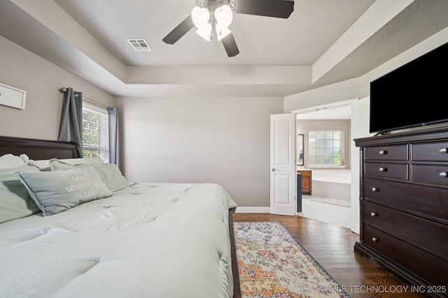 921 S 75th St, Broken Arrow, OK 74014 - bedroom featuring dark wood-type flooring, a raised ceiling, and ceiling fan