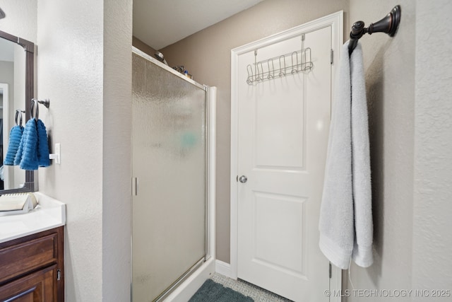 921 S 75th St, Broken Arrow, OK 74014 - bathroom with a stall shower, vanity, and a textured wall