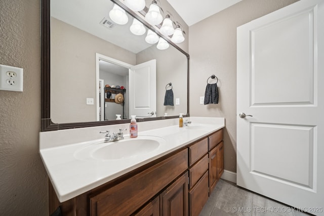 921 S 75th St, Broken Arrow, OK 74014 - bathroom featuring double vanity, a textured wall, and tile patterned flooring