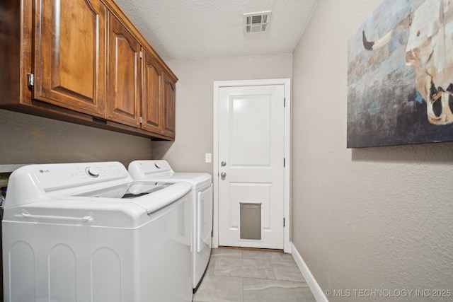 921 S 75th St, Broken Arrow, OK 74014 - laundry room with washing machine and clothes dryer, cabinet space, a textured ceiling, and light tile patterned flooring