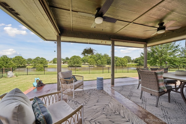 921 S 75th St, Broken Arrow, OK 74014 - fenced backyard with ceiling fan, a patio area, outdoor dining area, and a water view