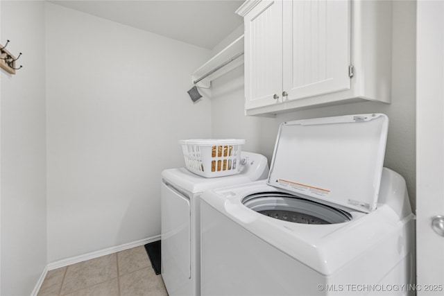 14907 E 88th St N, Owasso, OK 74055 - laundry room with washer and dryer, cabinet space, and light tile patterned flooring