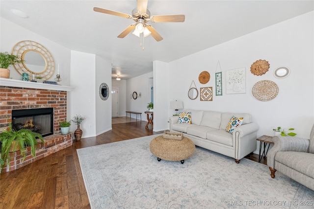 14907 E 88th St N, Owasso, OK 74055 - living area featuring wood finished floors, a ceiling fan, and a brick fireplace