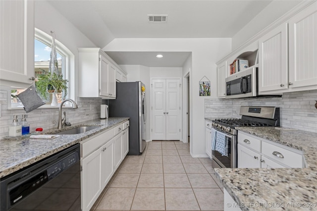14907 E 88th St N, Owasso, OK 74055 - kitchen featuring stainless steel appliances, white cabinets, tasteful backsplash, open shelves, and light stone countertops