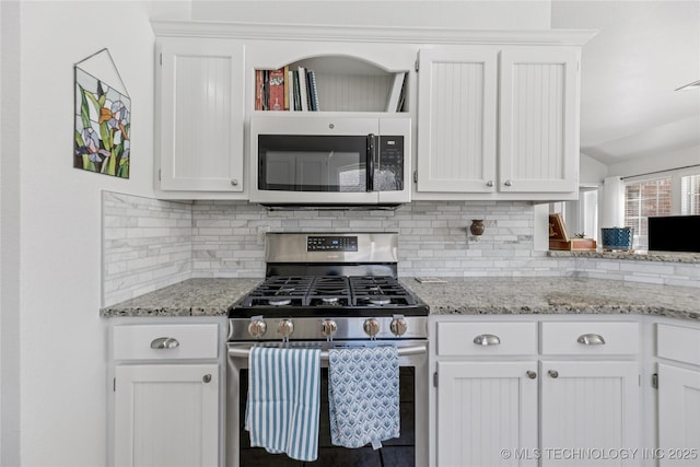14907 E 88th St N, Owasso, OK 74055 - kitchen featuring stainless steel gas range, decorative backsplash, white cabinetry, and light stone countertops