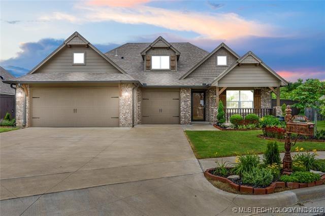 13244 S 19th St, Bixby, OK 74008 - craftsman inspired home featuring concrete driveway, a yard, a garage, brick siding, and a porch